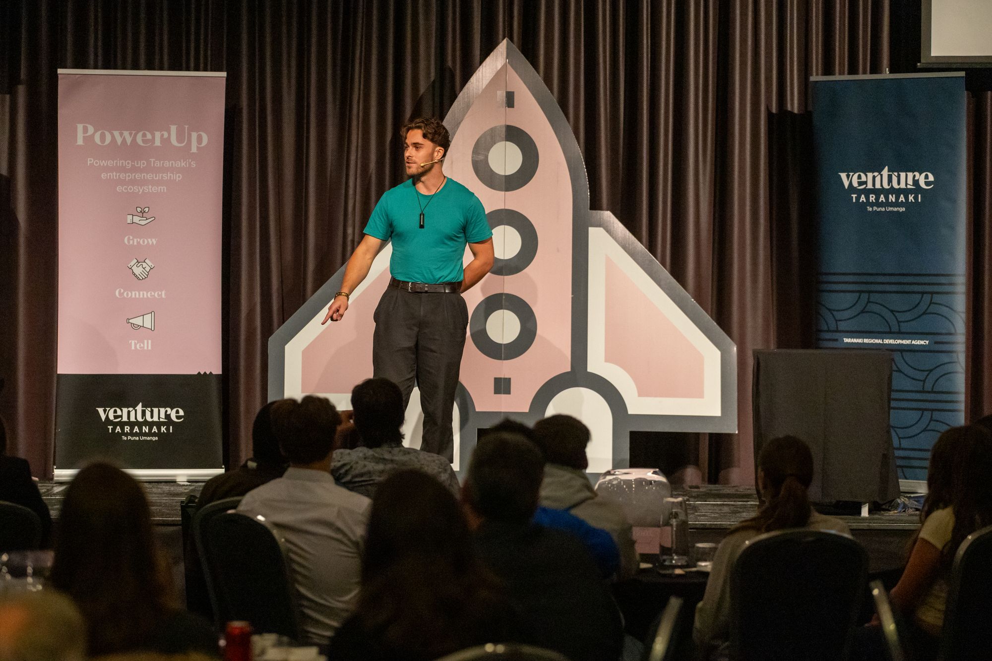 Fabian presenting FLYTTE on stage at PowerUp 2026 in Taranaki